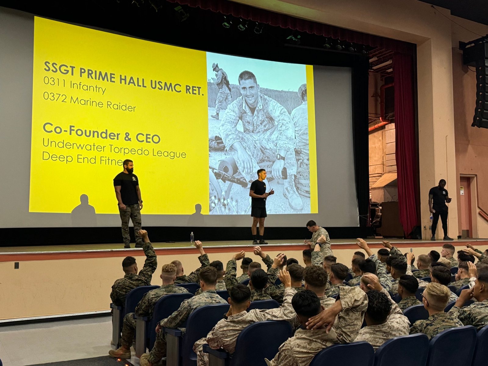 Prime Hall speaking to an auditorium of U.S. Marines