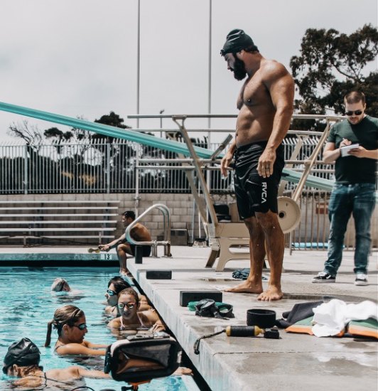Prime Hall coaching athletes from the pool deck